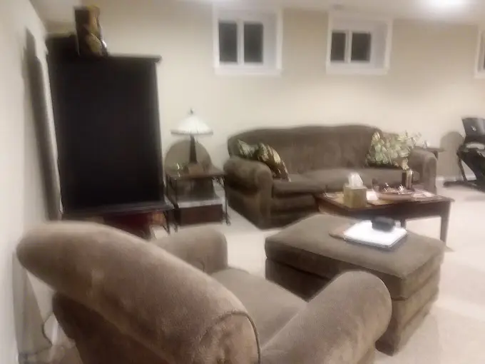 A living room with two couches and a television.