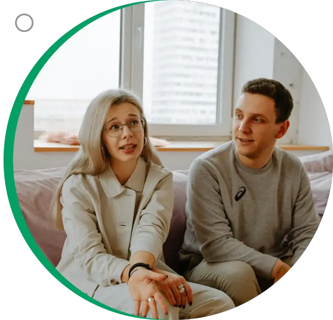 A man and woman sitting on top of a couch.