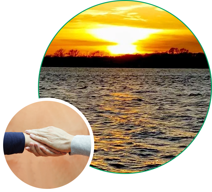 A picture of the sun setting over water with two hands shaking.